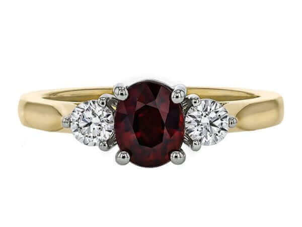 yellow Gold ring with oval ruby centre and 2 round white diamonds . top view