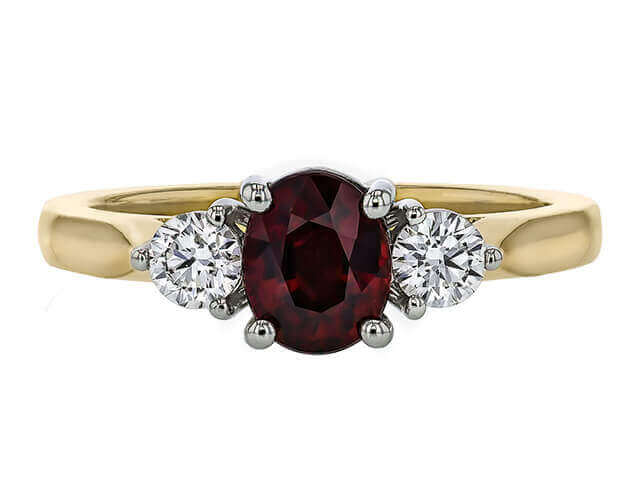 yellow Gold ring with oval ruby centre and 2 round white diamonds . top view
