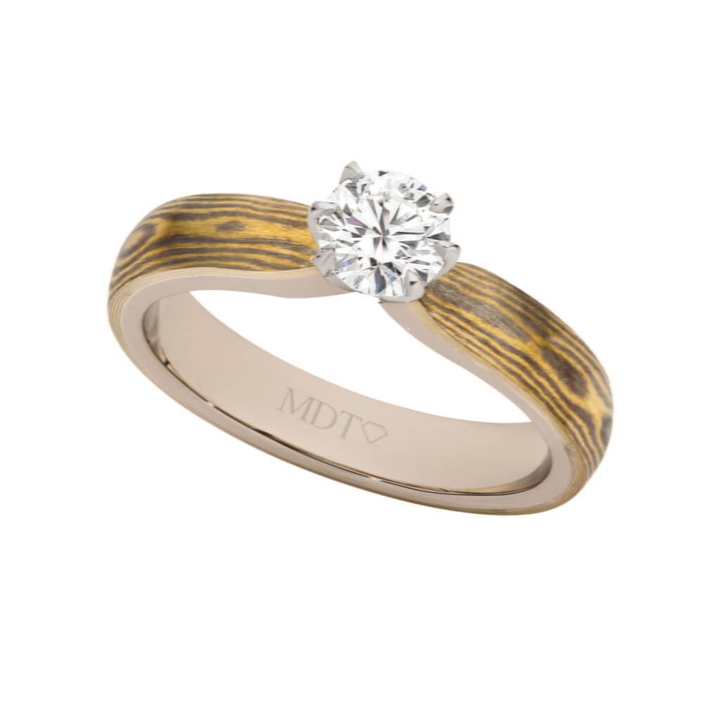 A solitaire diamond engagement ring with a two-tone metal band.