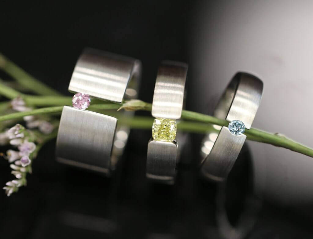 3 Coloured Diamond Tension Set Rings, 1 Yellow Diamond Tension Set, 1 Australian Argyle Pink Diamond and one Treated Blue Diamond