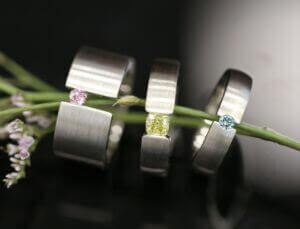 3 Coloured Diamond Tension Set Rings, 1 Yellow Diamond Tension Set, 1 Australian Argyle Pink Diamond and one Treated Blue Diamond