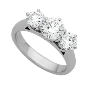 A white gold ring with three round-cut diamonds set in a row, exemplifying the timeless elegance of trilogy diamond engagement rings.