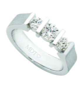 A white gold ring with three round diamonds bar set in a row on a band, perfect for those seeking the best trilogy diamond rings.