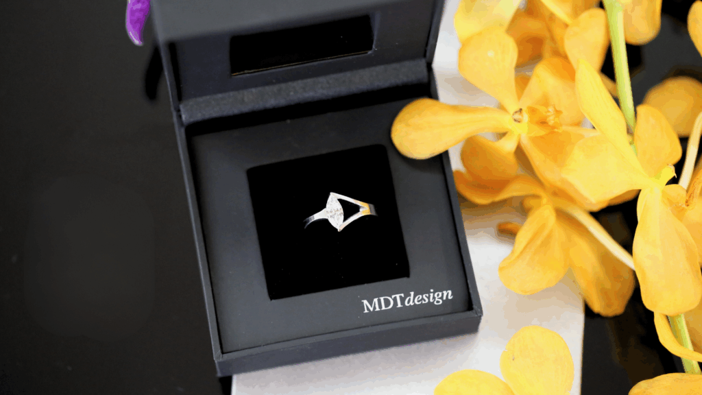 Tension Set Marquise ring sitting in a MDT DESIGN ring box
