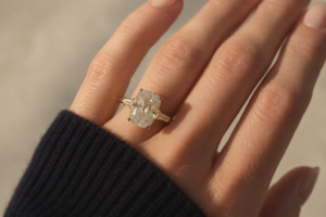 Jeweller’s interpretation of Taylor Swift’s engagement ring, featuring an elongated antique-style diamond with tapered side stones set in yellow gold.