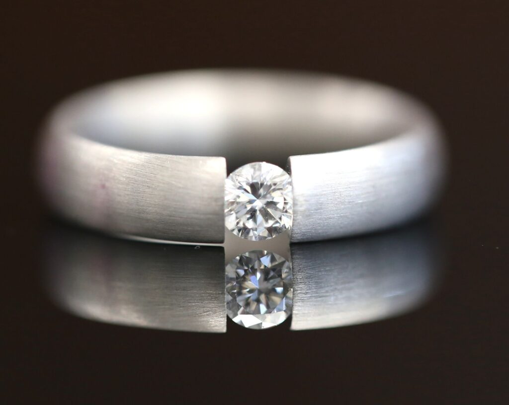 Handmade 18ct white gold tension set diamond ring with a round brilliant cut centre stone — modern minimalist design by MDT DESIGN Melbourne