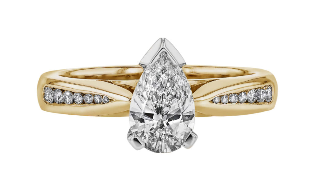 Yellow Gold and Platinum Engagement Ring with a Pear Cut Diamond at its centre and channel set round diamonds on either side of the band