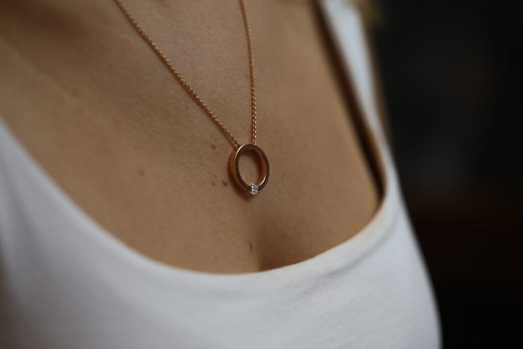 photo of a signature MDT DESIGN tension set diamond pendant in rose gold.