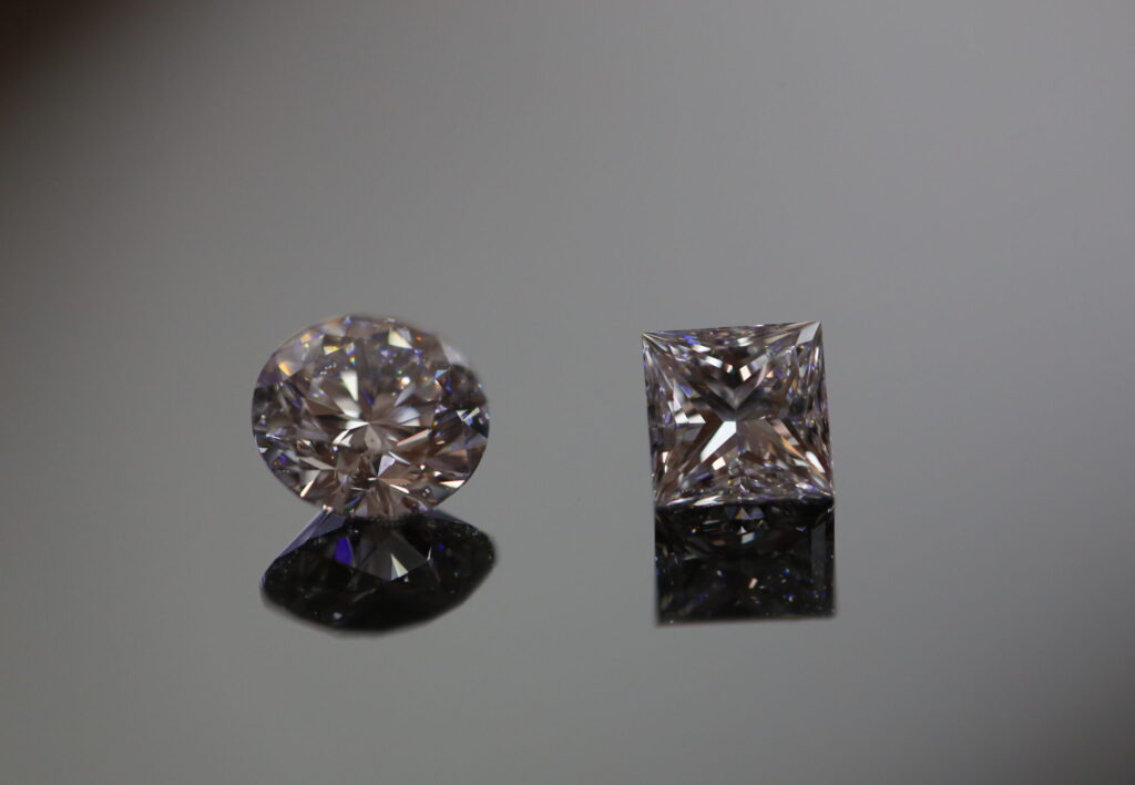 a loose round brilliant cut diamond and a princess cut diamond