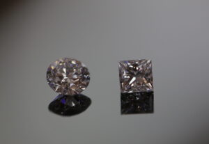 a loose round brilliant cut diamond and a princess cut diamond