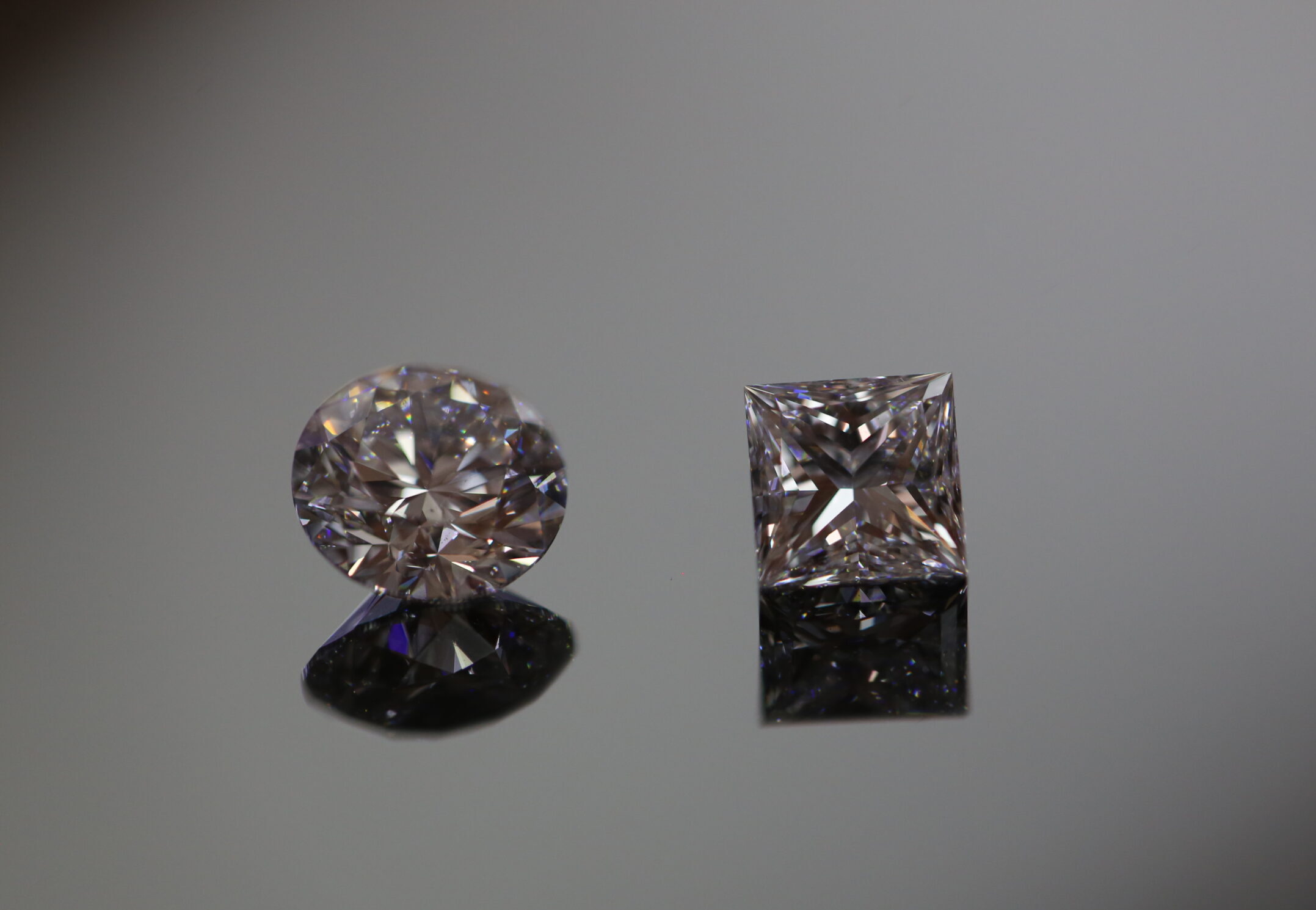 a loose round brilliant cut diamond and a princess cut diamond