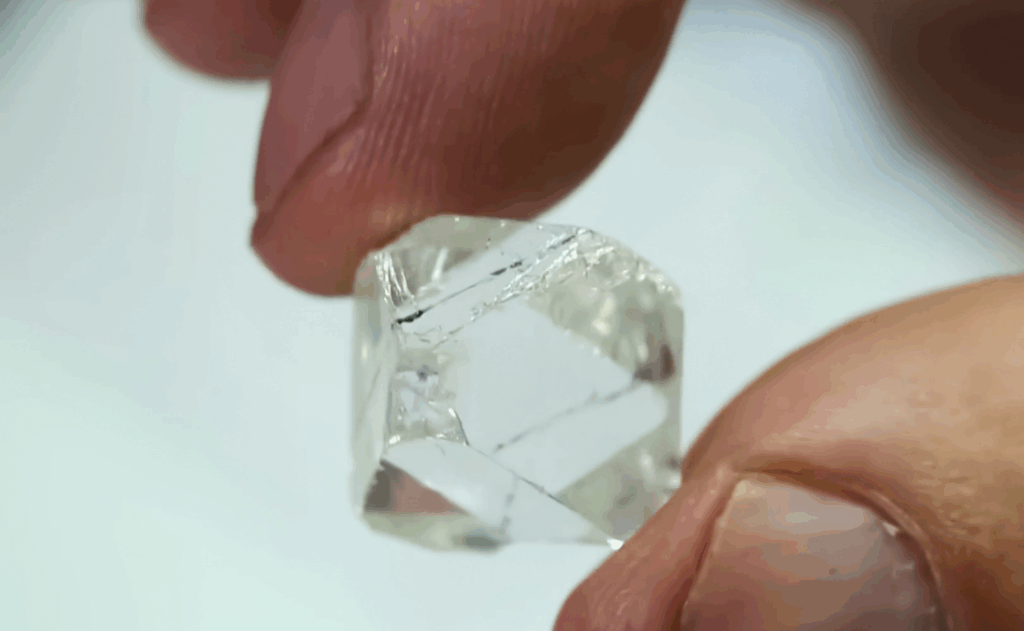 a rough diamond held between two fingers