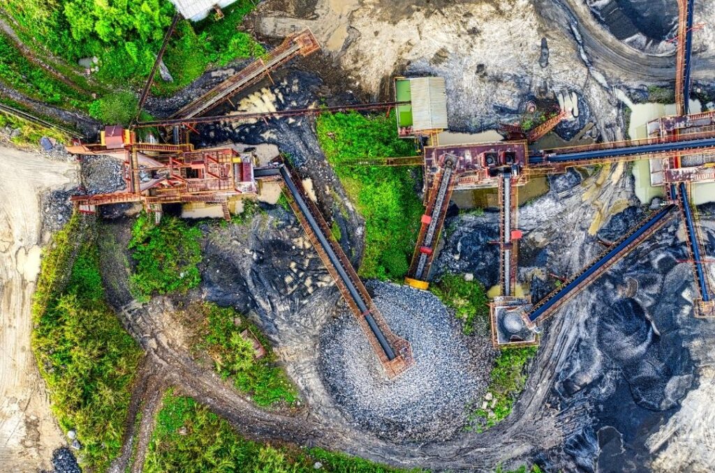 Aerial view of an active diamond mine showing mining equipment and excavation areas where natural diamonds are extracted
