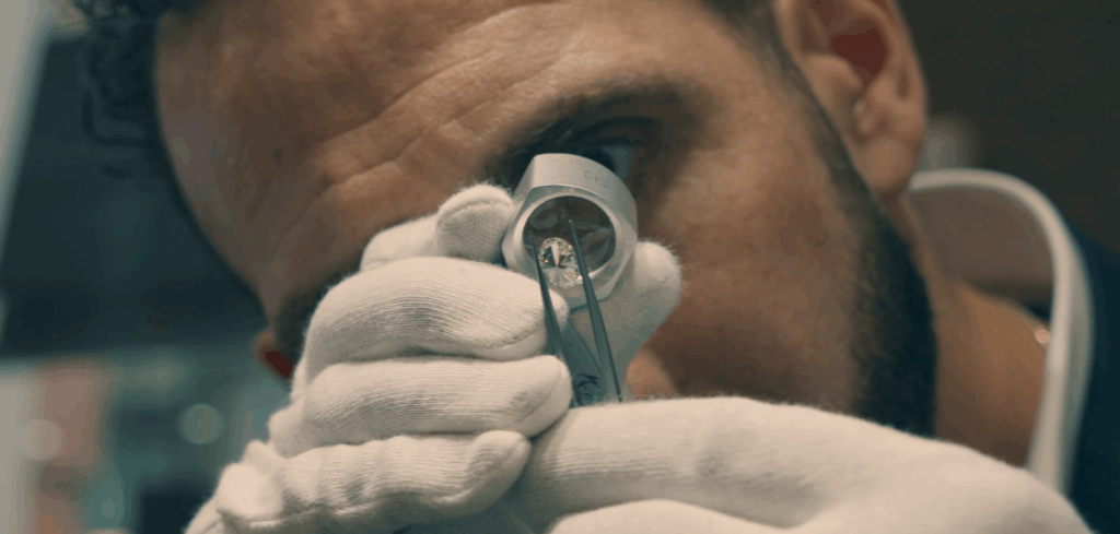 Master jeweller inspecting a diamond with a jeweller’s loupe during diamond grading and quality assessment in Melbourne.