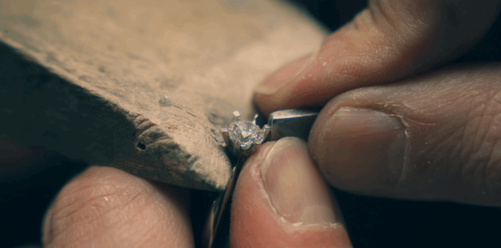 jeweller setting a diamond into engagement ring