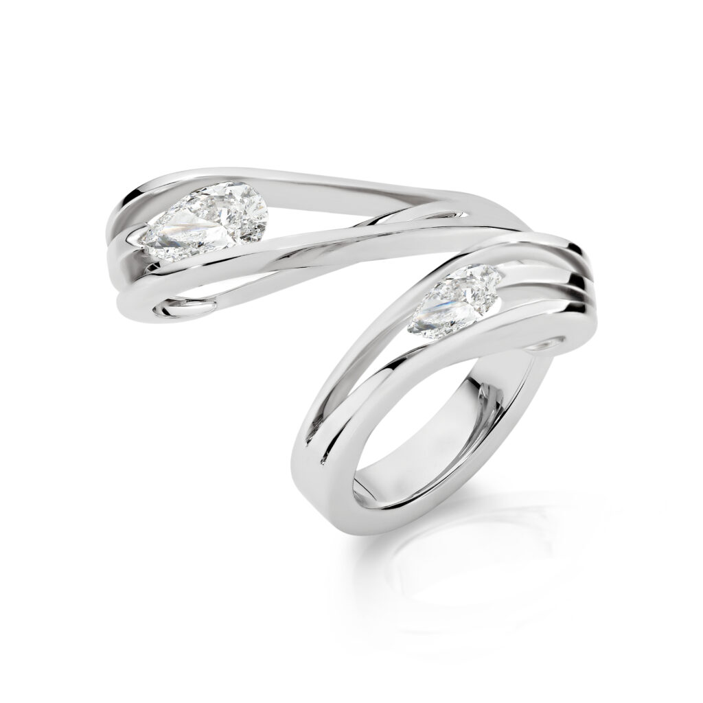 Freeflow twisted ring, in platinum, featuring two tension set diamonds at either end.