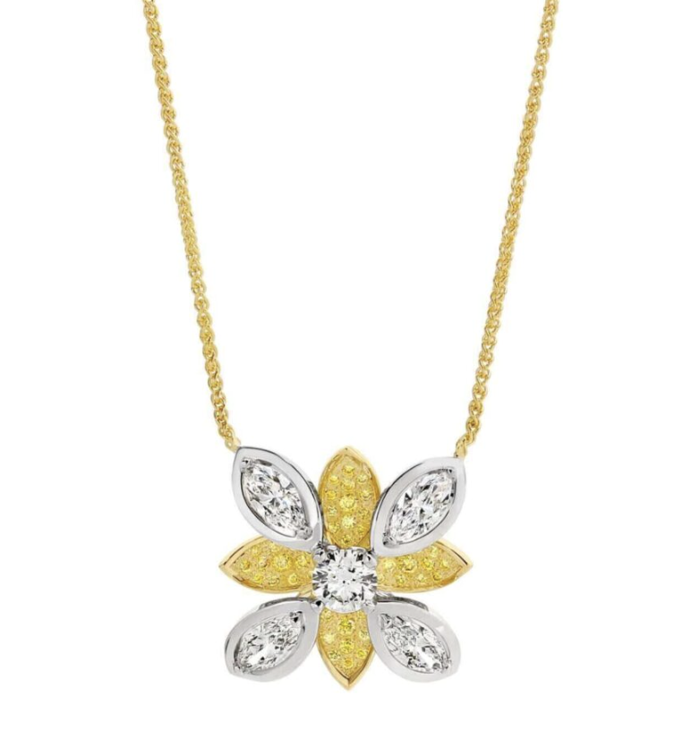 intricate three-dimensional flower-shaped pendant is expertly crafted in a combination of 18ct yellow and white gold, blending elegance with a sense of renewal. At the heart of the pendant lies a stunning 0.60ct round diamond, graded D in color with SI1 clarity, serving as the focal point of this captivating design. Surrounding the center diamond are four dazzling marquise diamonds, totaling 0.34ct each, with E+ color and SI1+ clarity, further enhancing the luxurious design.