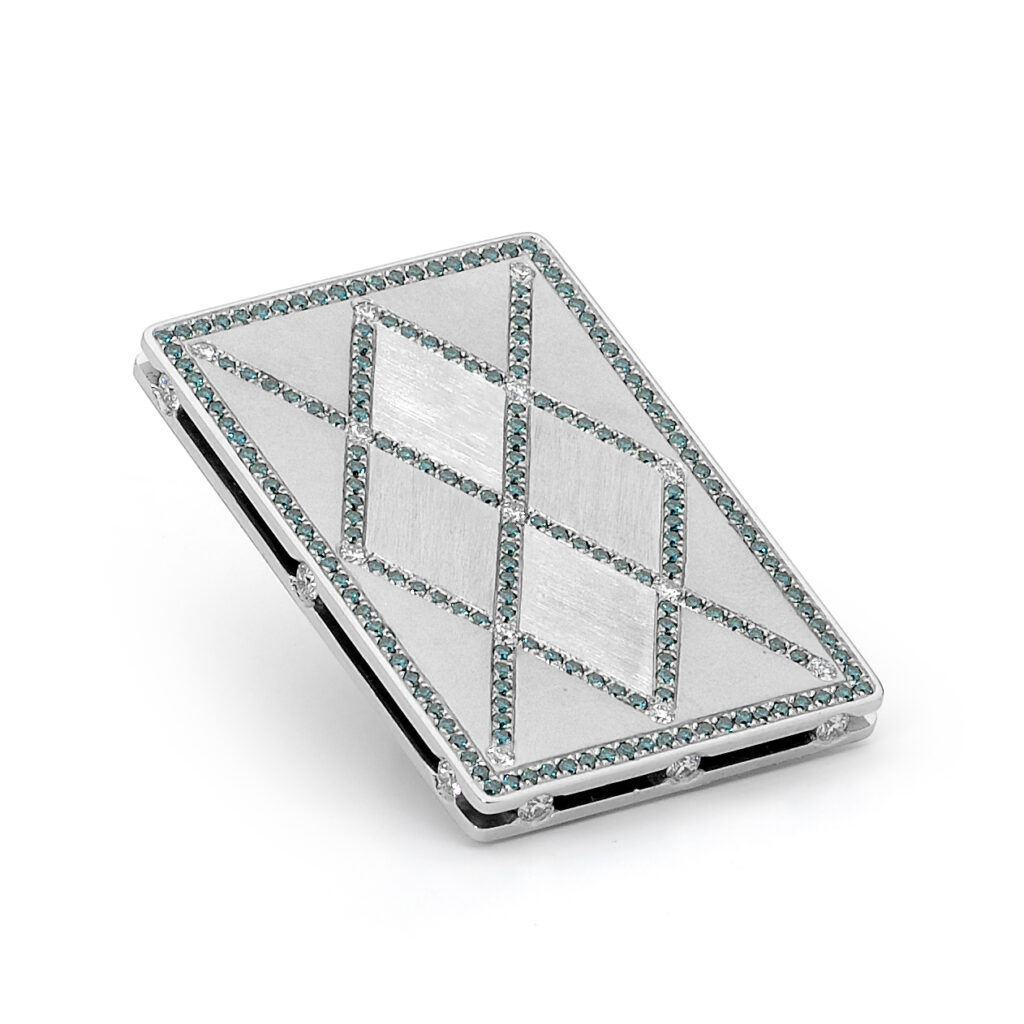 A cuff bracelet in platinum, designed to replicate an ace up the sleeve, set with white diamonds, black diamond and treated blue diamonds to replicate a ace card from a deck of cards