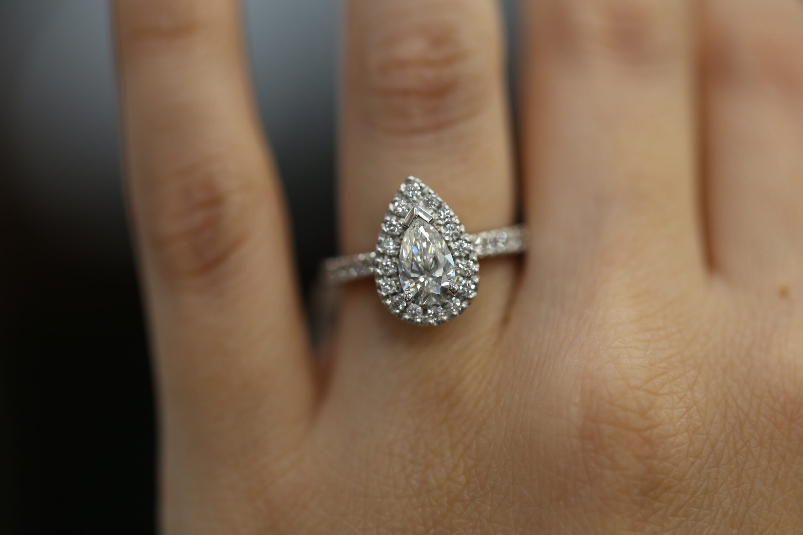 pear shaped halo engagement ring with pavé band in white gold featuring a lab grown diamond