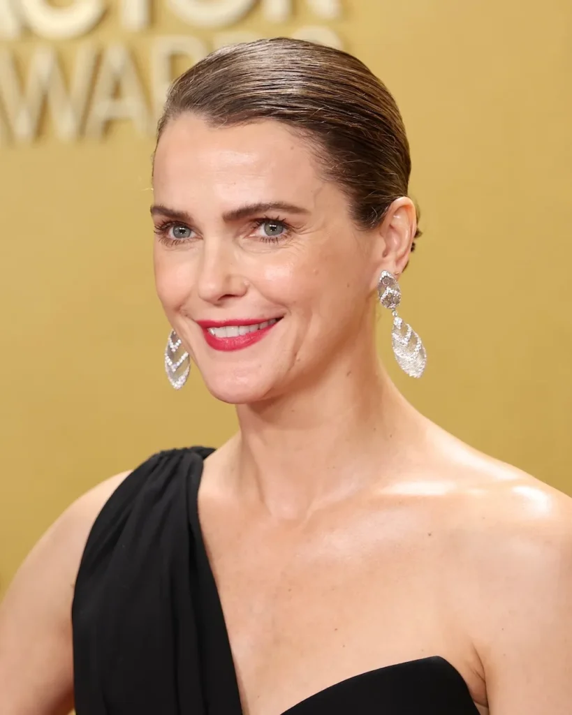 Keri Russell wearing layered white gold diamond drop earrings on the Actor Awards red carpet.