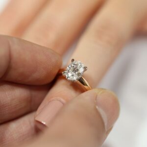 Handcrafted oval diamond engagement ring held in hand, custom made for a Melbourne proposal by MDT DESIGN.