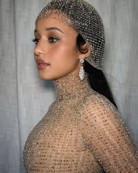 Behind the Scenes Chase Infiniti wearing vintage inspired diamond drop earrings with pavé set round brilliant diamonds standing in front of white curtain before the Actor Awards.