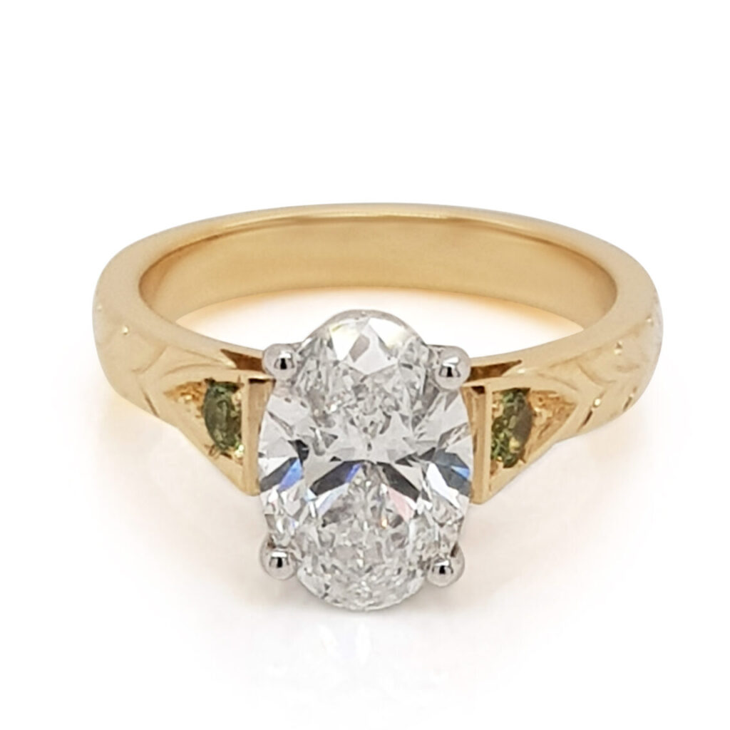 Custom Oval Diamond Engagement Ring with Green Sapphire Shoulders