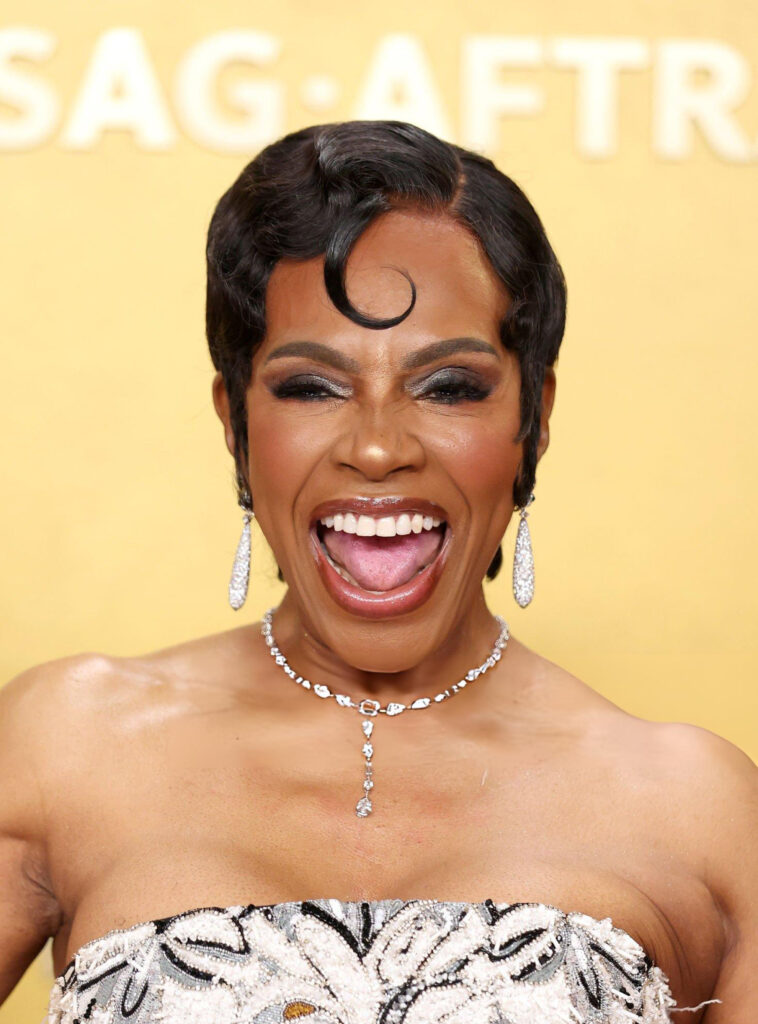 Sheryl Lee Ralph wearing a statement diamond necklace and pavé diamond drop earrings on the Actor Awards red carpet.