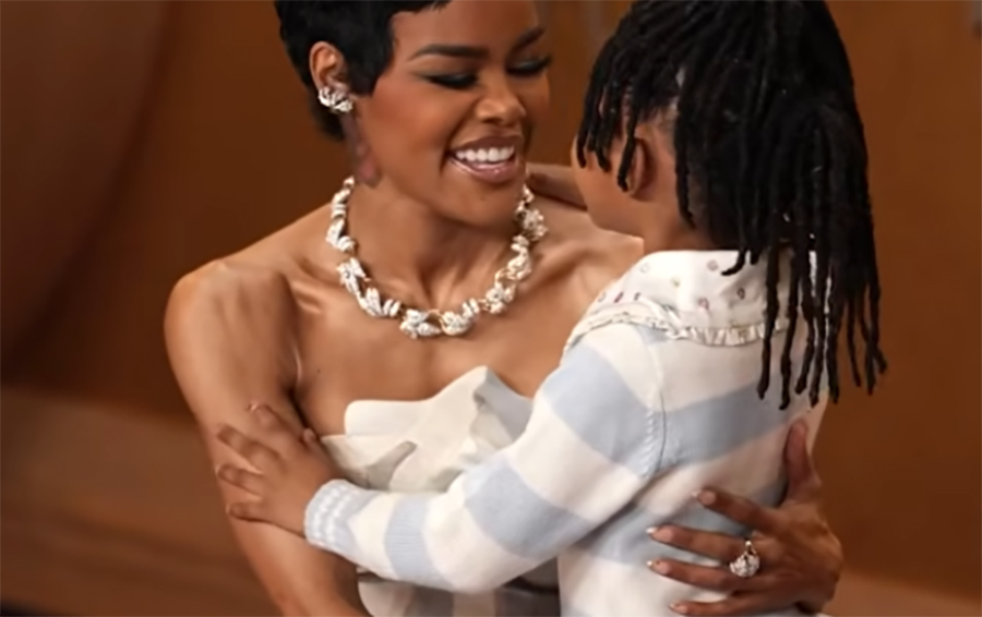 Teyana Taylor Embracing her child at the Actor Awards 2026 Red Carpet wearing a sculptural diamond collier necklace and matching earrings
