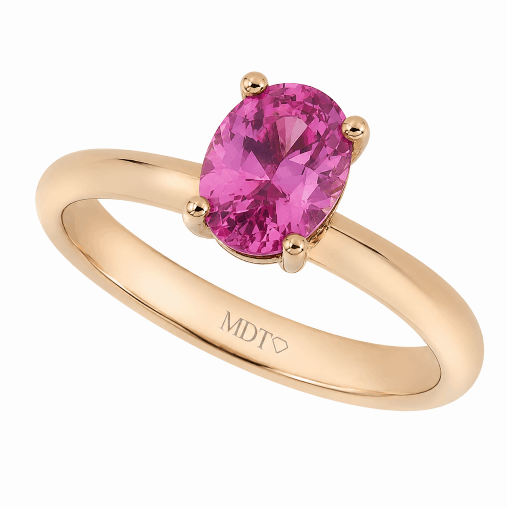 rose gold engagement ring featuring a vivid pink sapphire in the centre