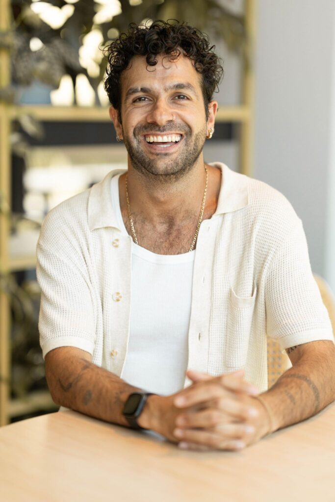 Image/ headshot of Steven Theochari, aka stevie bankster- smiling. Media marketing professional, singer/ songwriter, rnb