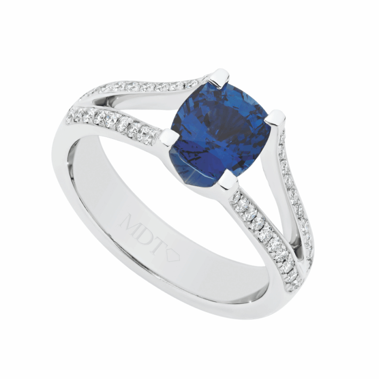 Custom handmade white gold engagement ring featuring a deep blue sapphire centre stone with diamond set shoulders, individually made in Melbourne.