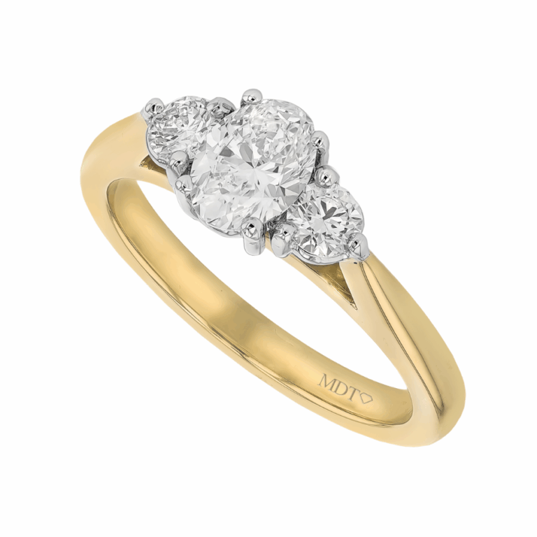 Handmade yellow gold three stone engagement ring featuring an oval cut centre diamond with round brilliant side diamonds in a claw setting, custom made in Melbourne.