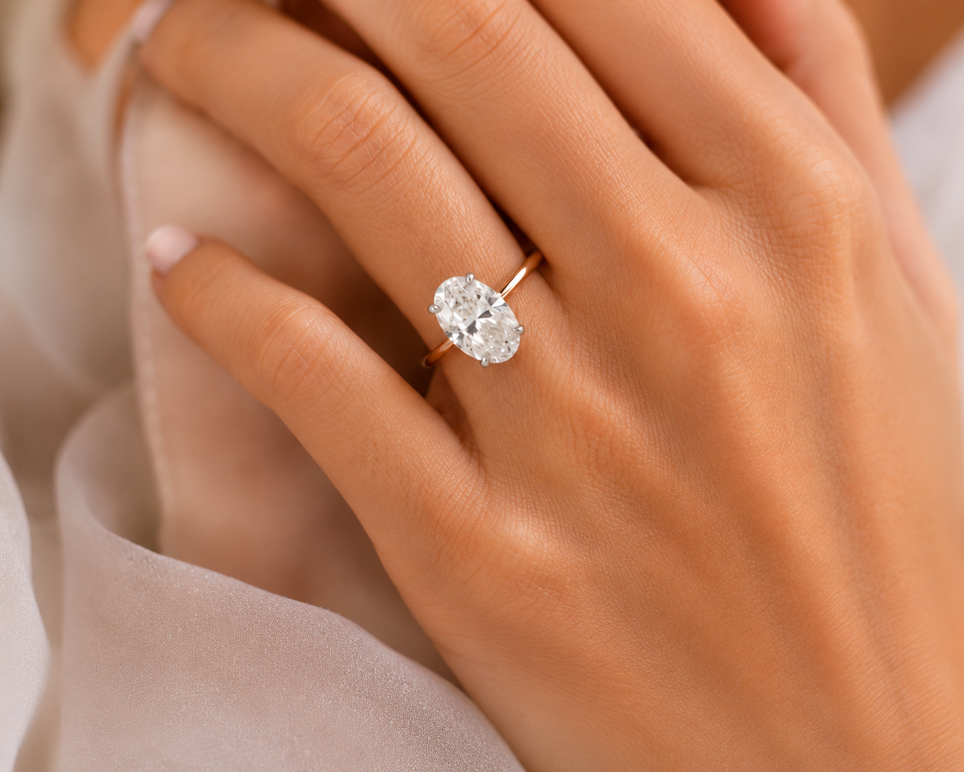 Oval-cut diamond solitaire engagement ring with platinum claws and a fine 18ct rose gold band, inspired by Sophia Stallone’s engagement ring.