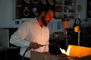 Kosta Theochari handmaking jewellery at the jeweller’s bench in the MDT DESIGN Melbourne workshop, continuing his family’s legacy of traditional jewellery craftsmanship.