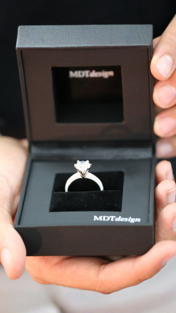 Handmade diamond solitaire engagement ring presented in an MDT DESIGN ring box, showcasing the finished piece ready for its new owner.