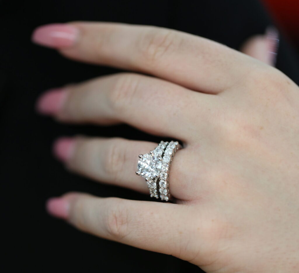 handmade Diamond engagement ring paired with matching diamond wedding bands, showing carefully considered stone size, spacing and proportions for a seamless fitted set.