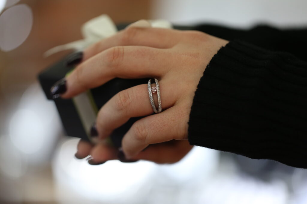 Diamond engagement ring worn on the hand, showing the jewellery that becomes part of life after the proposal.