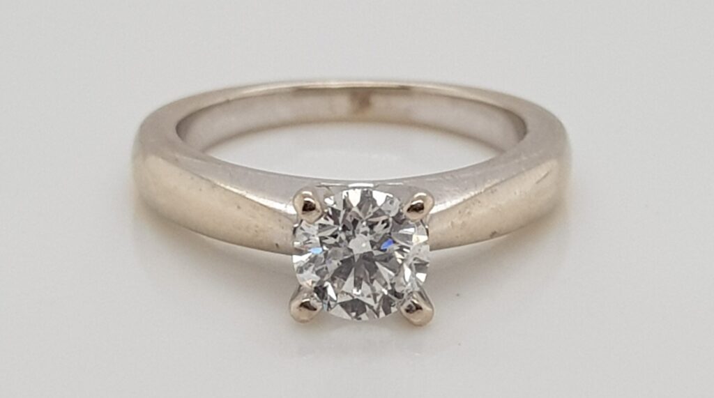 18ct white gold diamond engagement ring showing a warmer yellow tone where the rhodium plating has worn away.