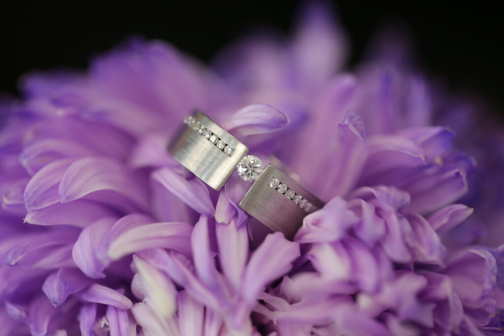 Wide Diamond-Set Band – MDT DESIGN White metal tension set ring featuring a round brilliant diamond between wide diamond-set shoulders.